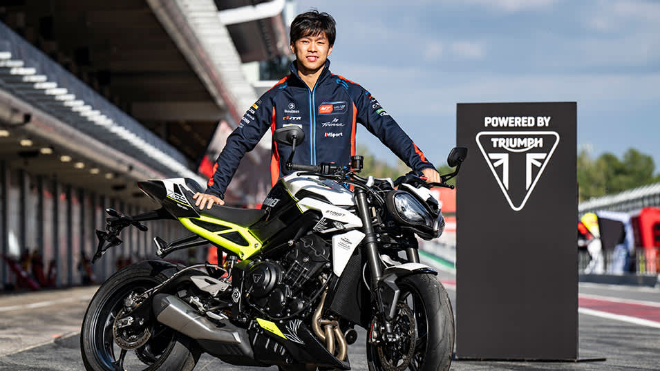 Ai Ogura Standing with a Triumph Street Triple 765 race bike