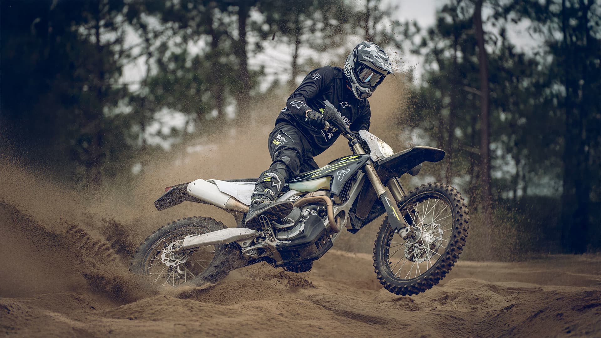 Triumph TF 250-E riding shot through mud