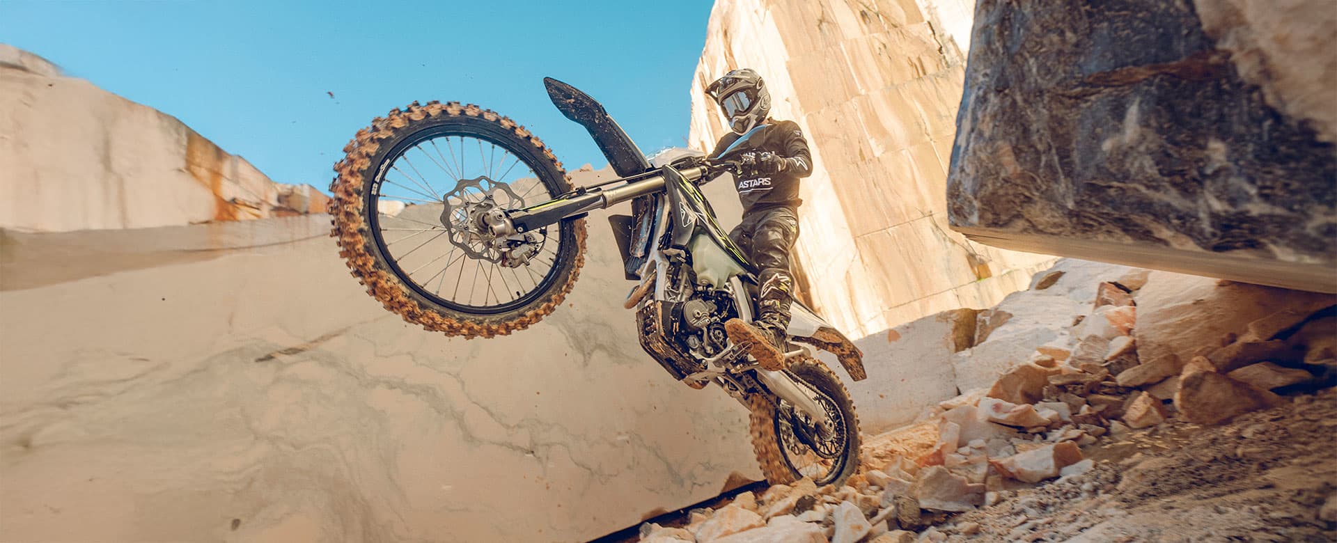 Triumph TF 250-E riding shot one wheel in the air