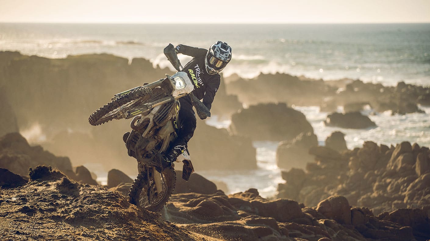 Triumph TF 250-E riding shot one wheel in the air