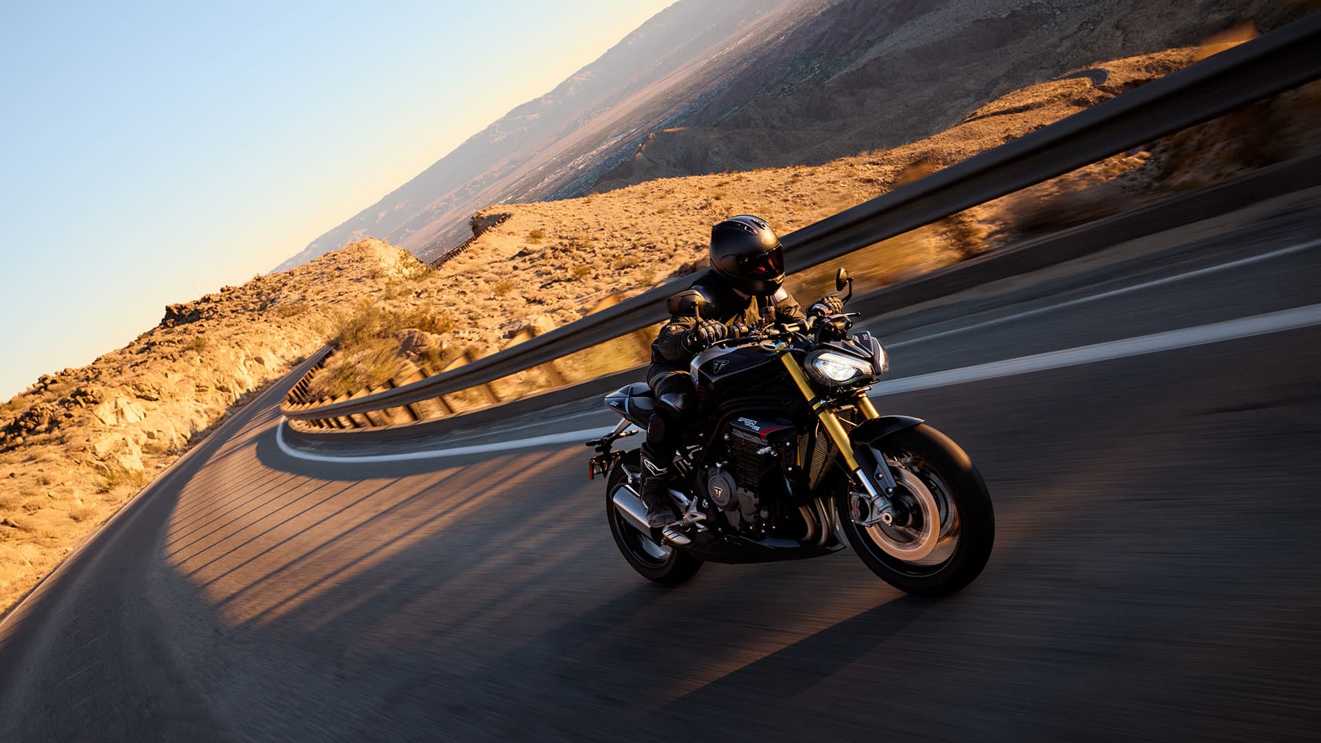 Triumph Speed Triple 1200 RS riding through a stunning scenery