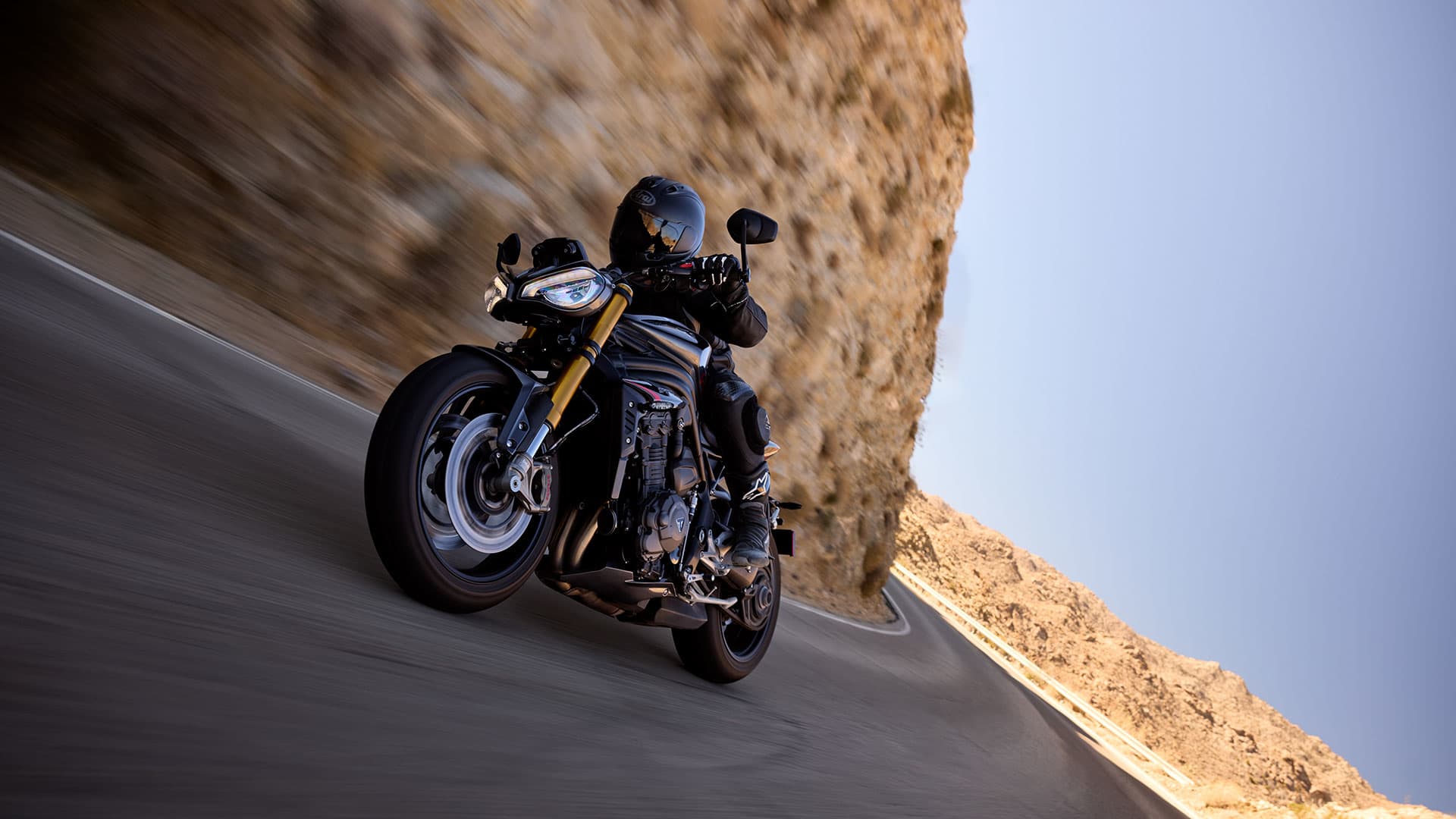 Triumph Speed Triple 1200 RS riding through a stunning scenery