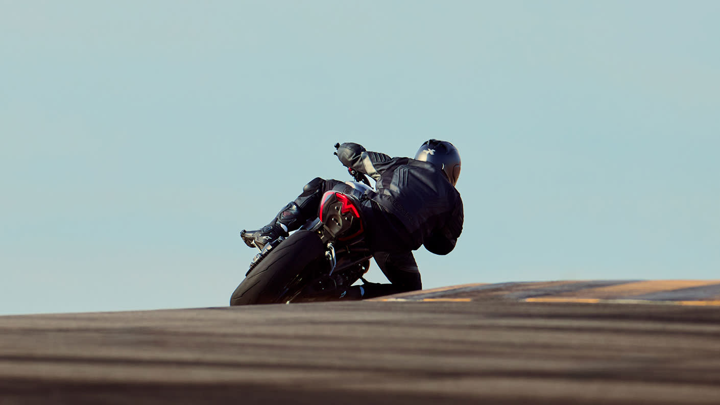 Triumph Speed Triple 1200 RS riding away into the distance