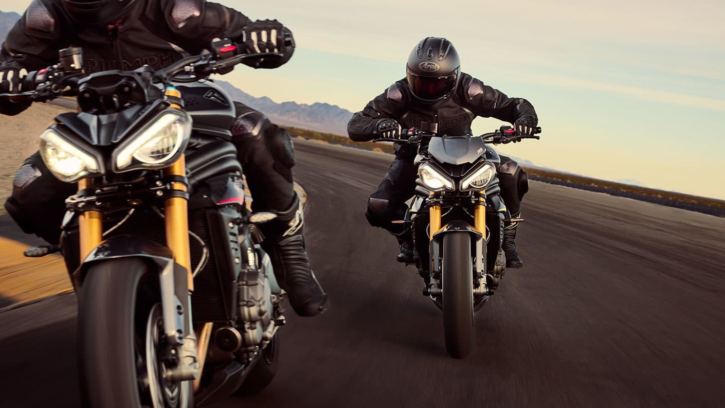 Triumph Speed Triple 1200 RS ridden by two riders on the track